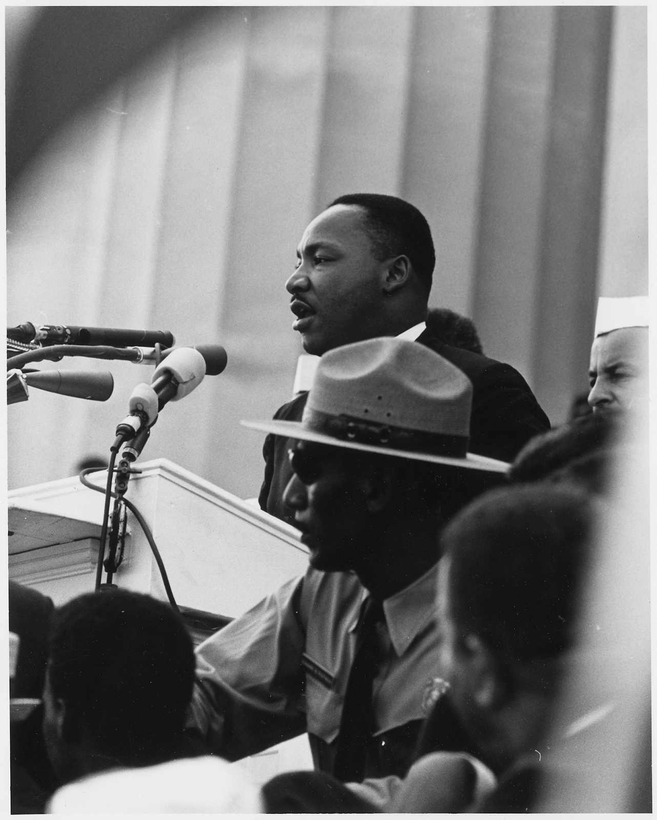 man talking in front of microphone