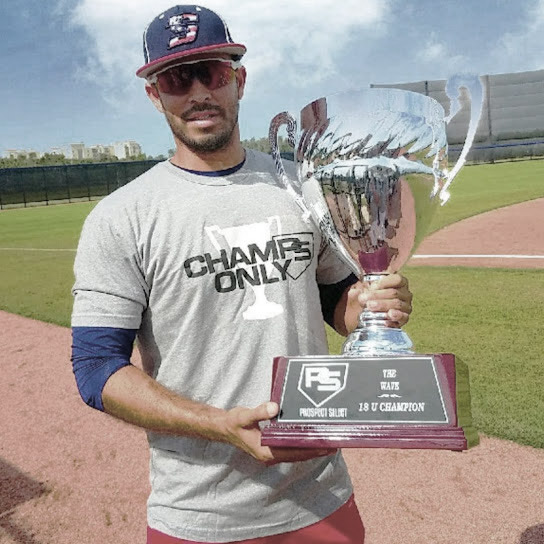 Baseball Coach AJ Quinones Holding Champion Cup